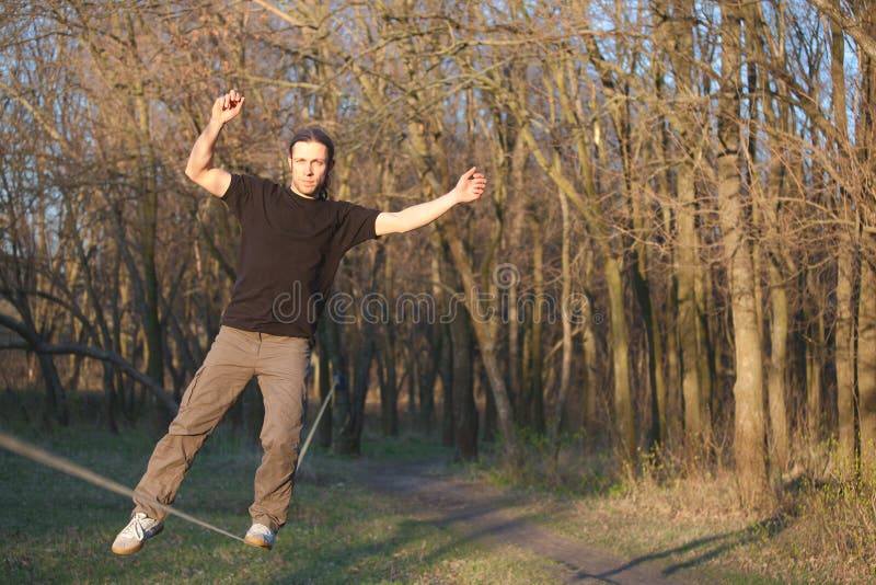 Man walking on slackline stock image. Image of tightrope 71931479