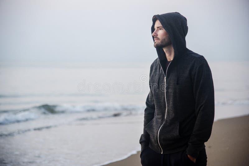 Man walking in solitude at the beach stock image