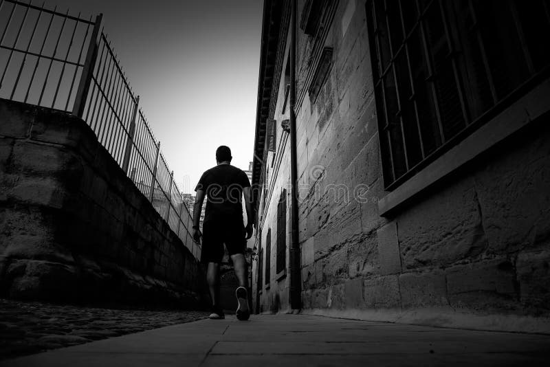 Man walking through the town stock images