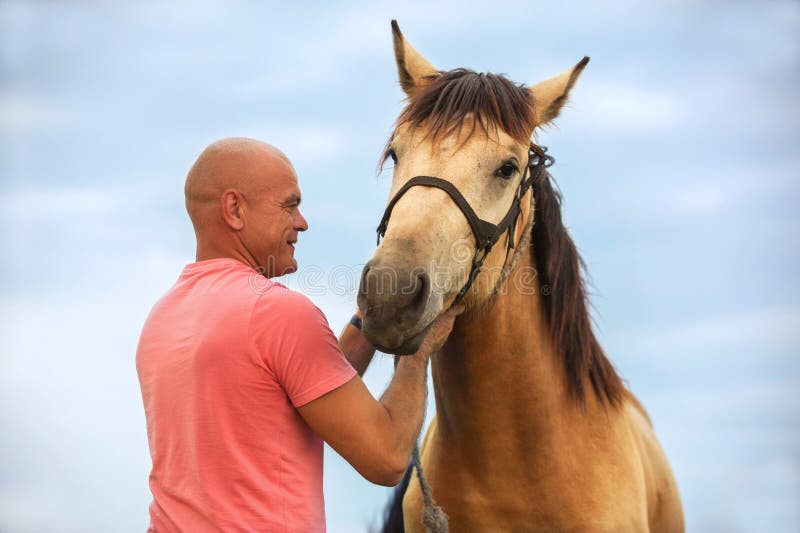 A man walks with his horse