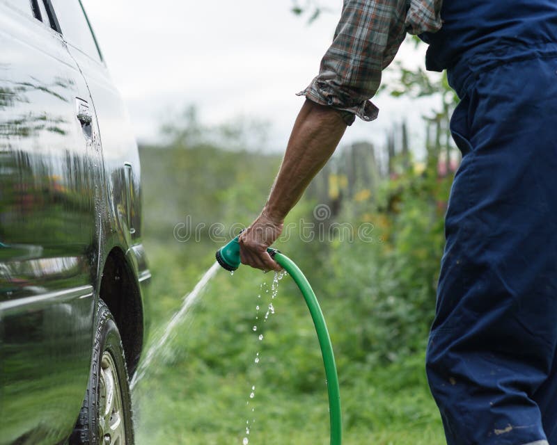 Man Washes His Car on Background of Green Garden Stock Image Image of