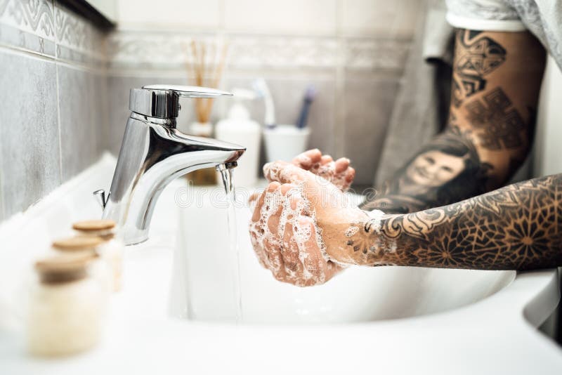 Antiseptic Hand Washing Practice with Soap and Water in Bathroom