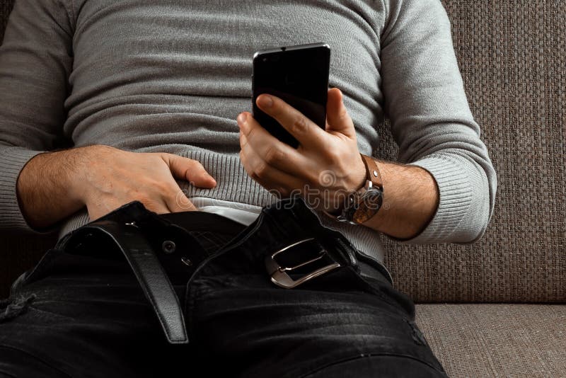 A Man Watches an Adult Video on a Phone while Sitting on a Couch. the  Concept of Porn, Masturbation, Male Needs, Pervert, Lust, Stock Image -  Image of excite, erotic: 144460073