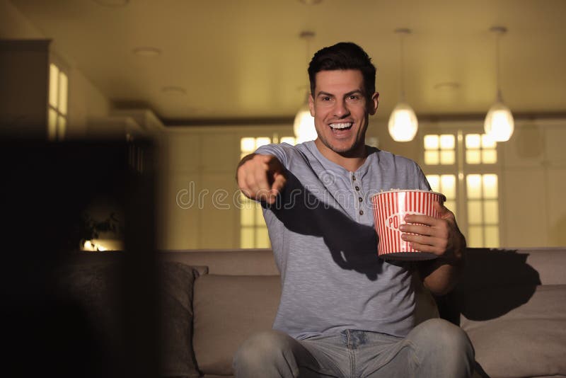 Man Watching Movie with Popcorn on Sofa at Night Stock Photo Image of