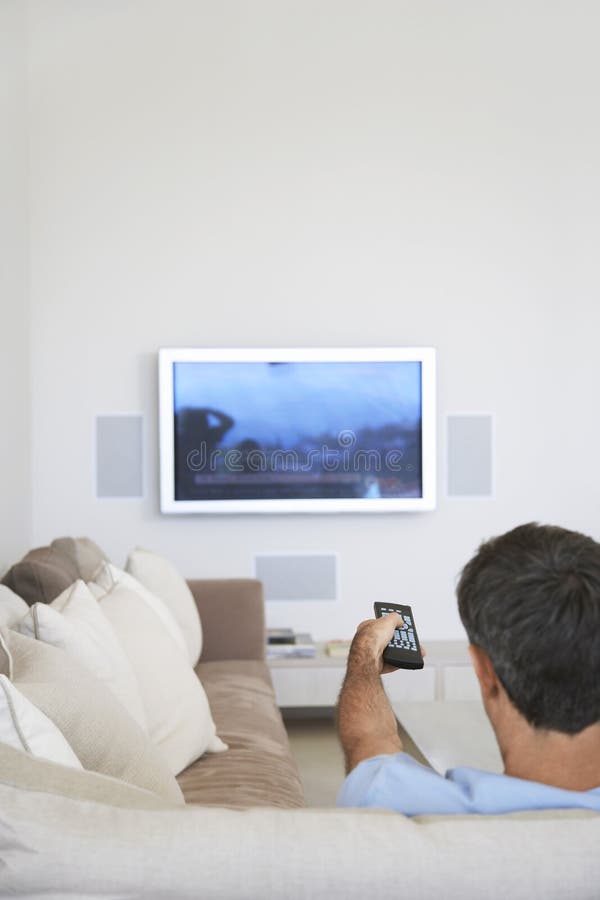 Man Watching Television In Living Room stock images