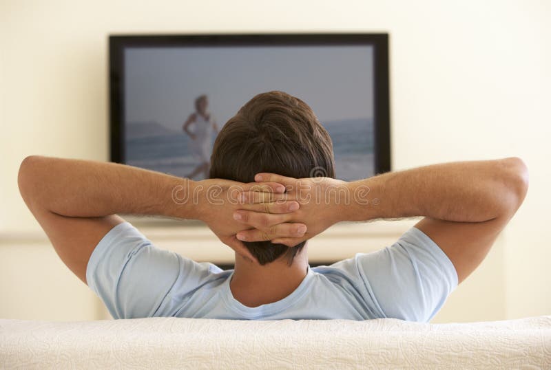 Man Watching Widescreen TV At Home