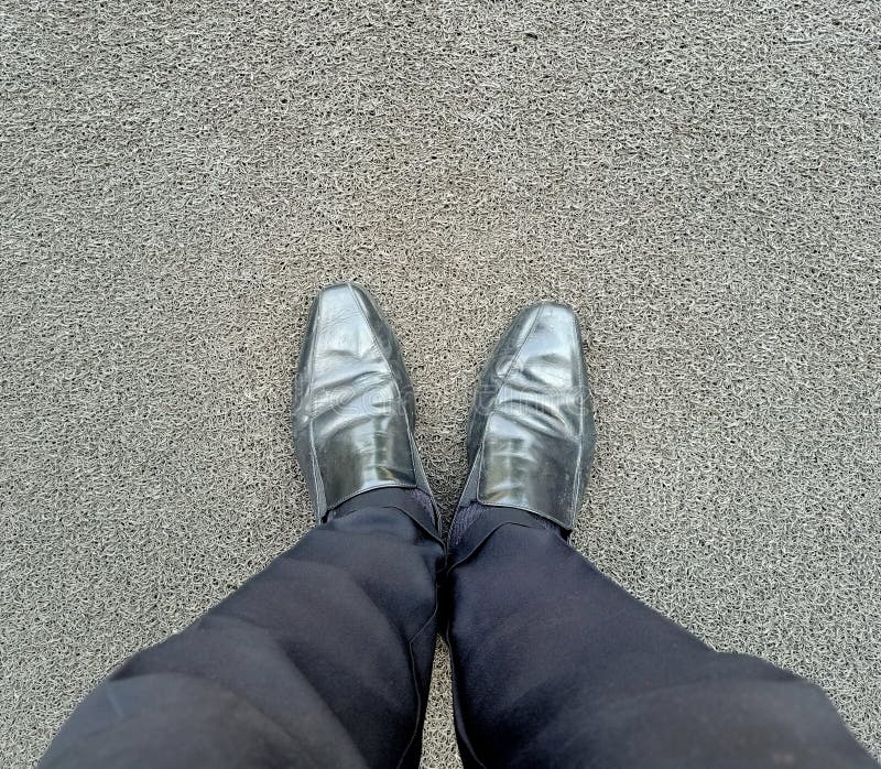 The Man Wearing Black Pants and Black Shoes Standing on the Poles, Feet ...