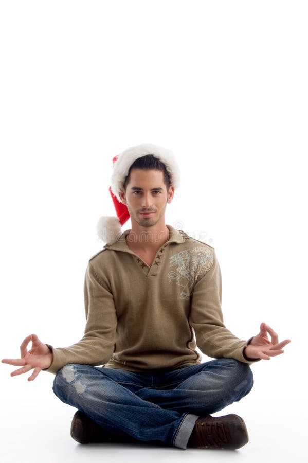 Man wearing christmas hat and doing meditation