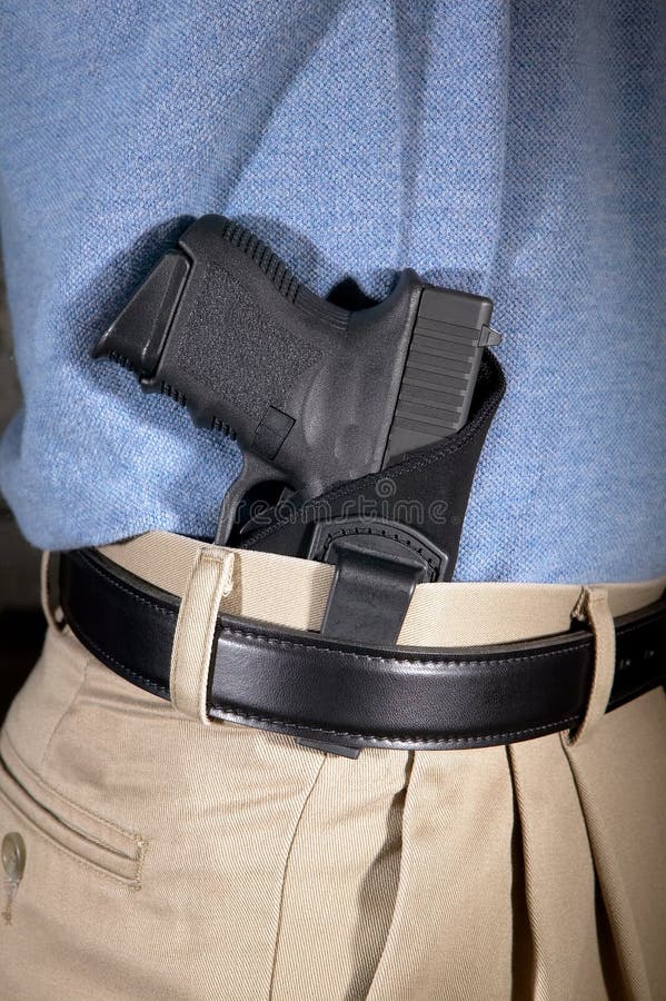 Man wearing a handgun in a clip on holster