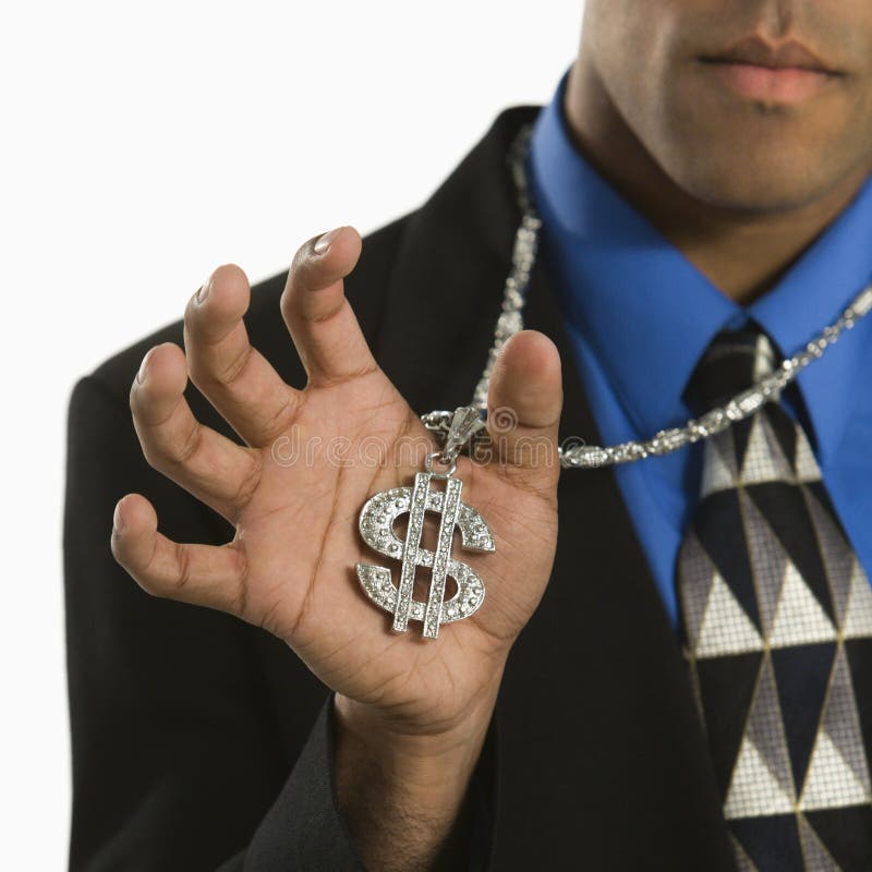 African American man wearing necklace with money sign. African American man wearing necklace with money sign.