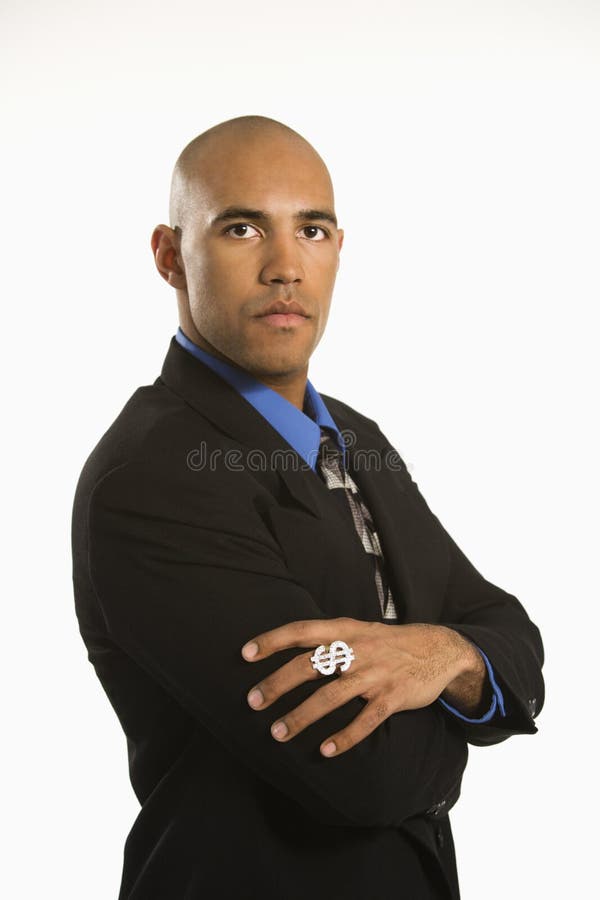 African American man in suit wearing ring with money sign. African American man in suit wearing ring with money sign.