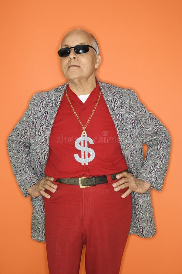 Mature adult Caucasian male wearing money sign necklace. Mature adult Caucasian male wearing money sign necklace.