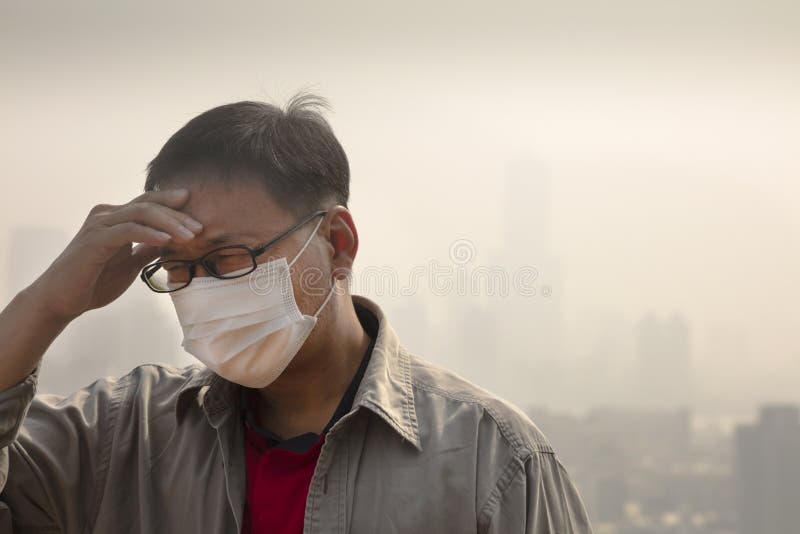 Man wearing mouth mask against air pollution