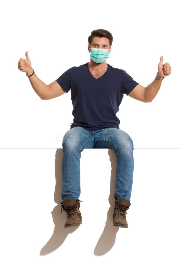 Man Wearing Protective Face Mask is Sitting on a Top and Showing Thumbs ...