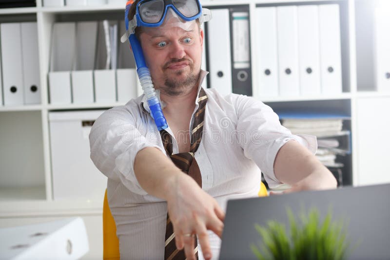 Man wearing suit and tie in goggles and snorkel
