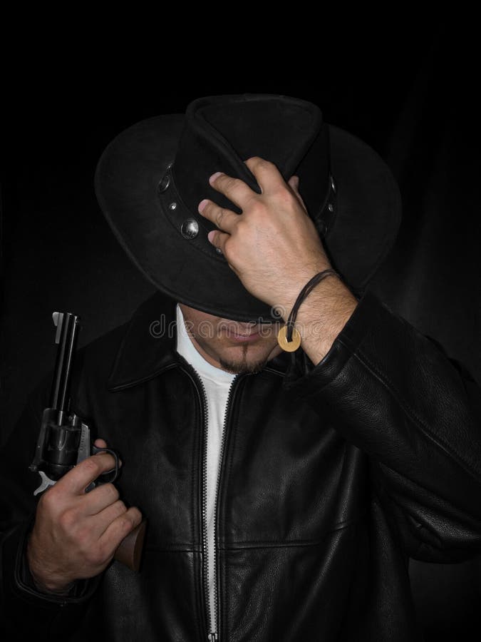 Man With Western Revolver Looks Downward