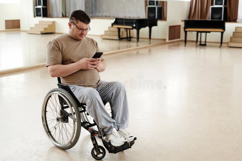 Man In Wheelchair Using Smartphone stock photos