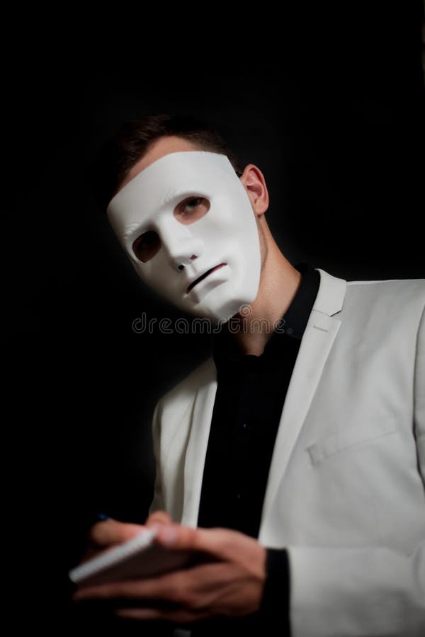 Man in a White Mask in a White Jacket Black Background Writes in Notebook Stock Image Image of costume, abstract: 150171015