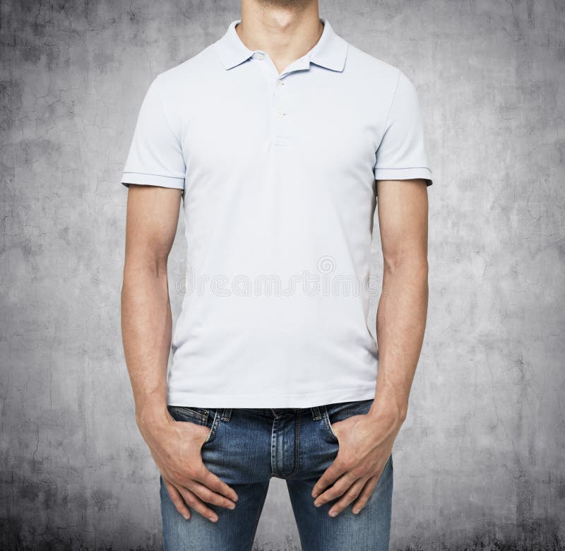 A man in a white polo shirt and denims holds his hands in pockets. stock images A man in a white polo shirt and denims holds his hands in pockets. stock images