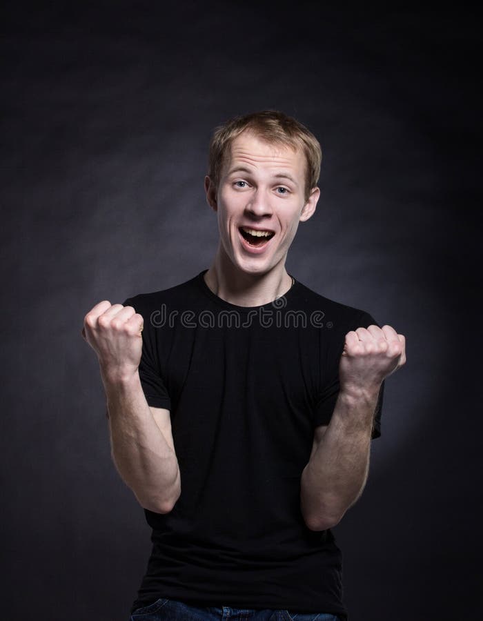 Man winner pose on black background