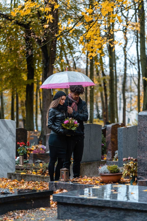 Man and woman on a cemetery with flowers royalty free stock photos Man and woman on a cemetery with flowers royalty free stock photos