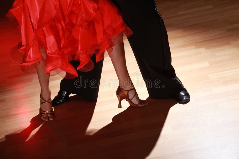 Man and woman dancing Salsa on dark background