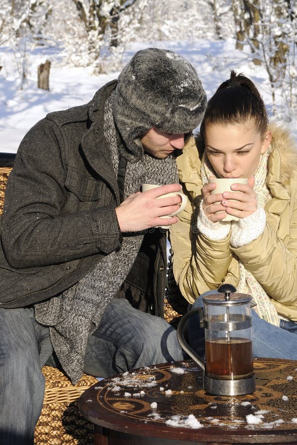 Man and woman drinking in nature