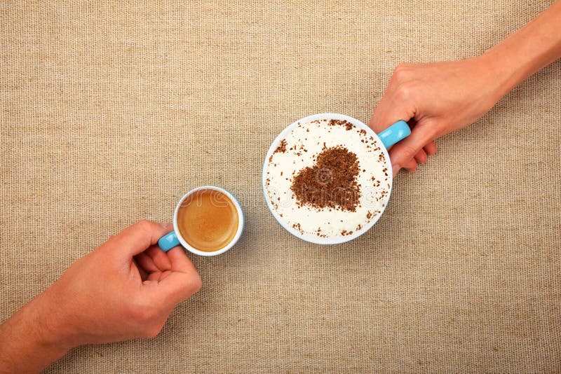 Man and woman hands hold full latte coffee cup