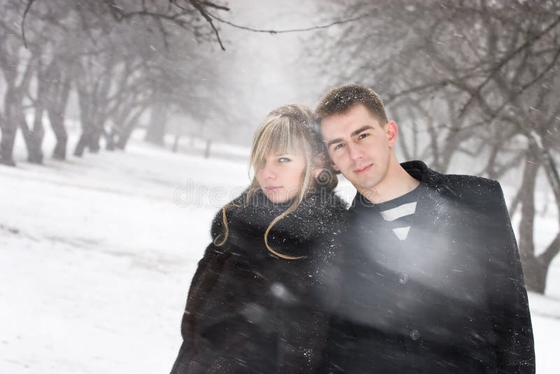 Man and woman in love in blizzard