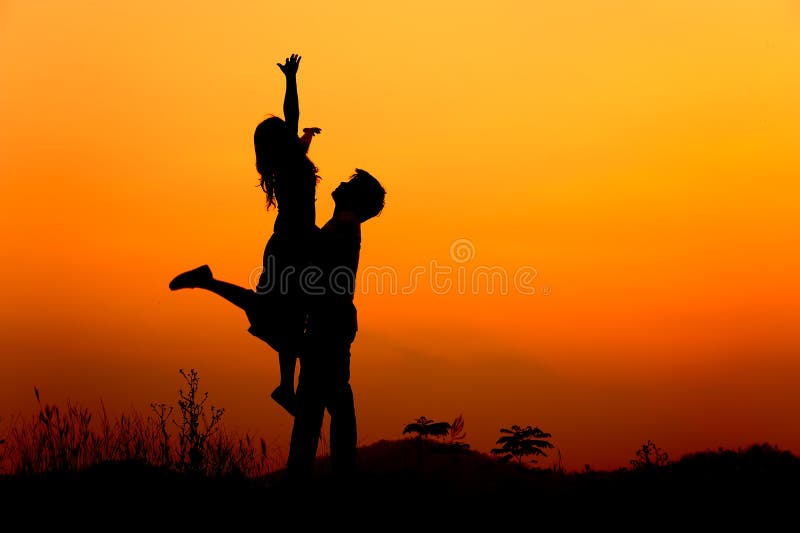 Man and Woman love silhouette in sunset