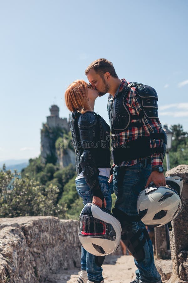 Man and Woman Loving Couple are Kissing. Dressed in a Motorcycle Outfit.  Body Protection Turtle and Knee Pads, Helmet in Hand Stock Image - Image of  antique, couple: 173213521