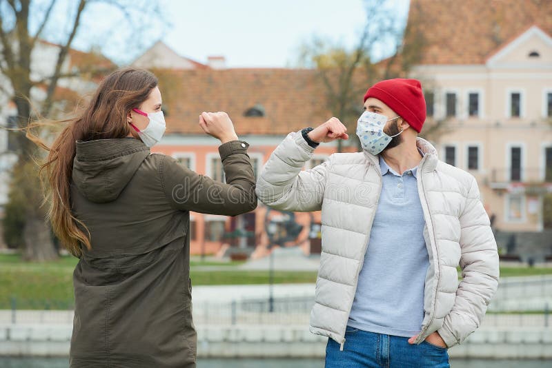 A Man and a Woman in Masks Bump Elbows instead of Greeting with a ...