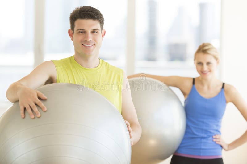 Man And Woman With Pilates Smiling In Health Club stock images Man And Woman With Pilates Smiling In Health Club stock images