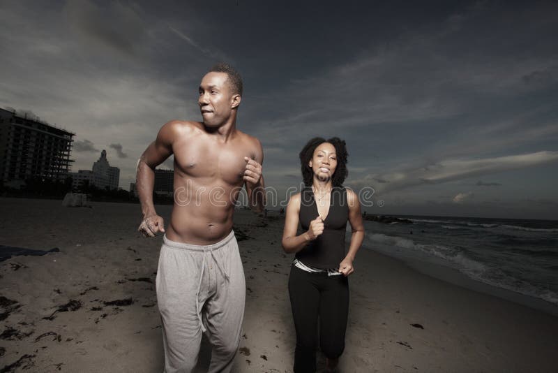 Man and woman running on the beach