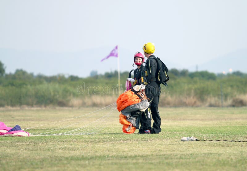 Man and woman skydiving and lover partners talking after success stock images Man and woman skydiving and lover partners talking after success stock images