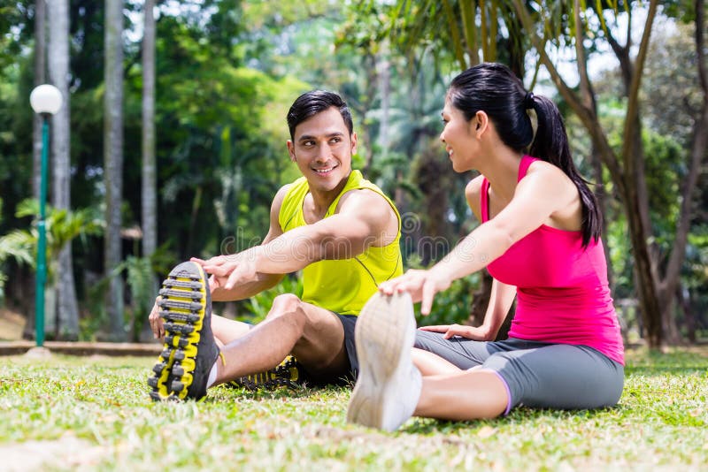 Man and woman at sport gymnastics in park