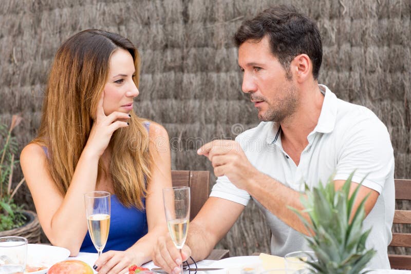 Man and woman talking over a glass of champagne