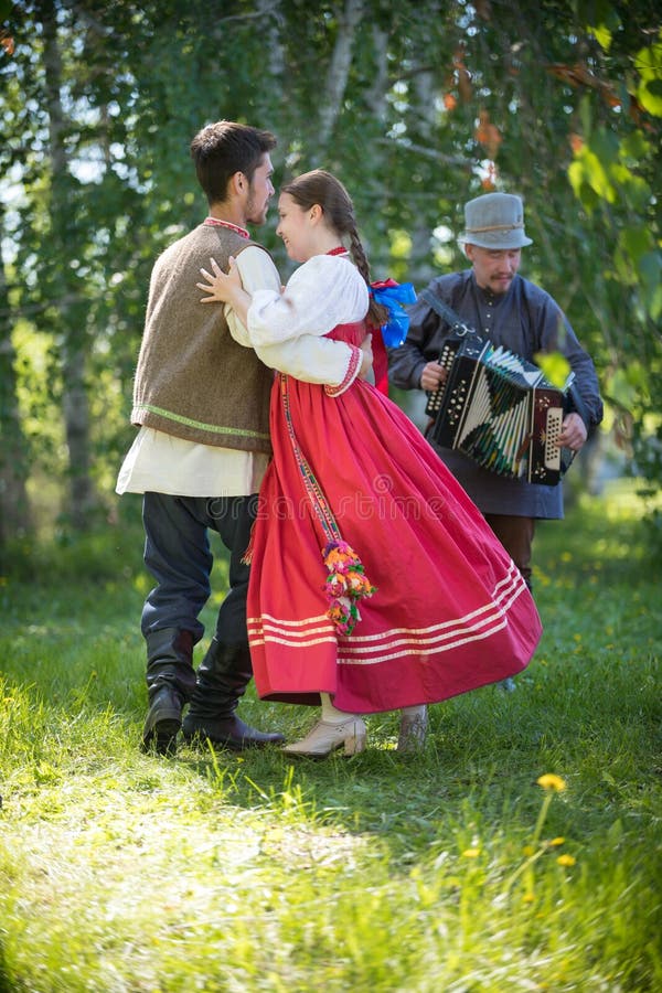 Man and Woman in Traditional Russian Clothes are Performing Russian ...