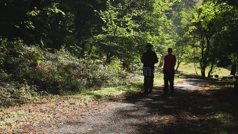 Man and woman walking outdoors on sunny day