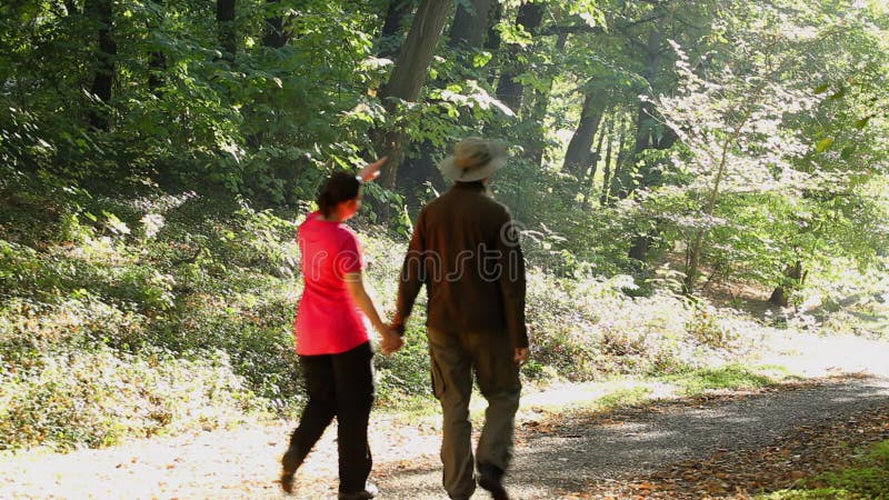 Man and woman walking outdoors on sunny day