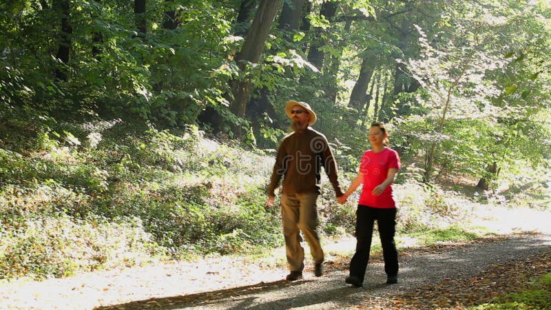 Man and woman walking outdoors on sunny day