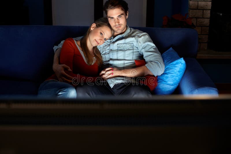 Man and woman watching movie on tv