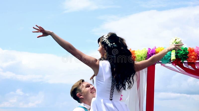 Man and woman, young people, happy married adult couple dancing near wedding arch.