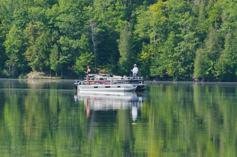 Man and women fishing on pontoon Boat