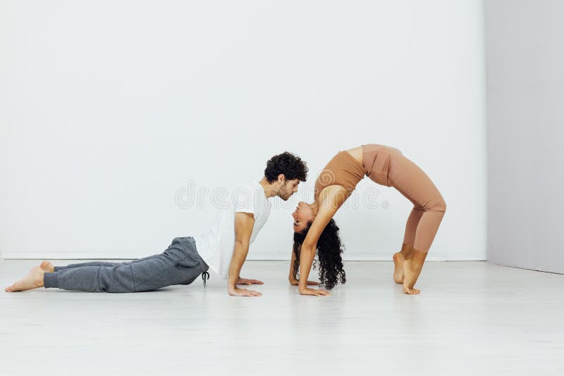 Mother, father and daughter stand in a yoga pose. Family yoga in the  studio. Stock Photo | Adobe Stock