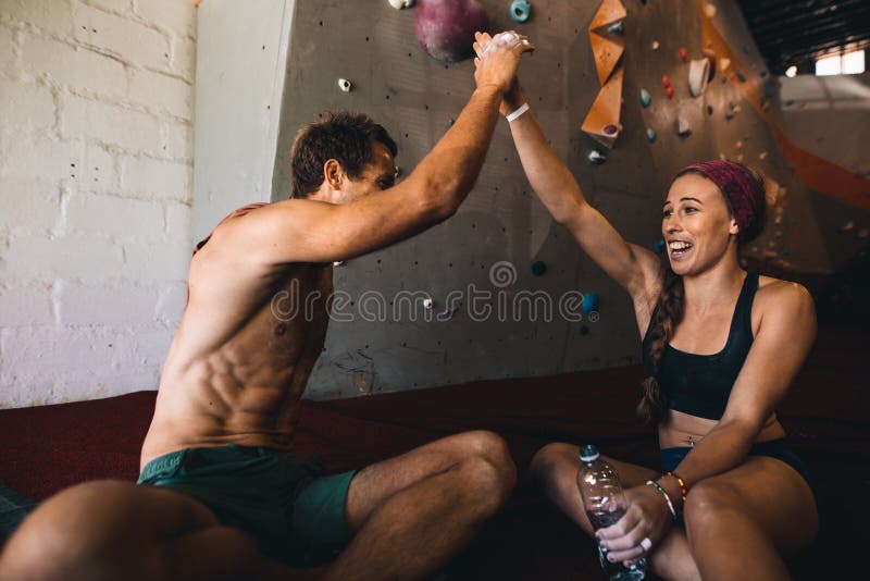 Rock climbers celebrating at a wall climbing gym