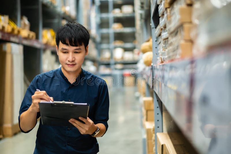 Man Worker Holding Clipboard and Checking Inventory in the Warehouse