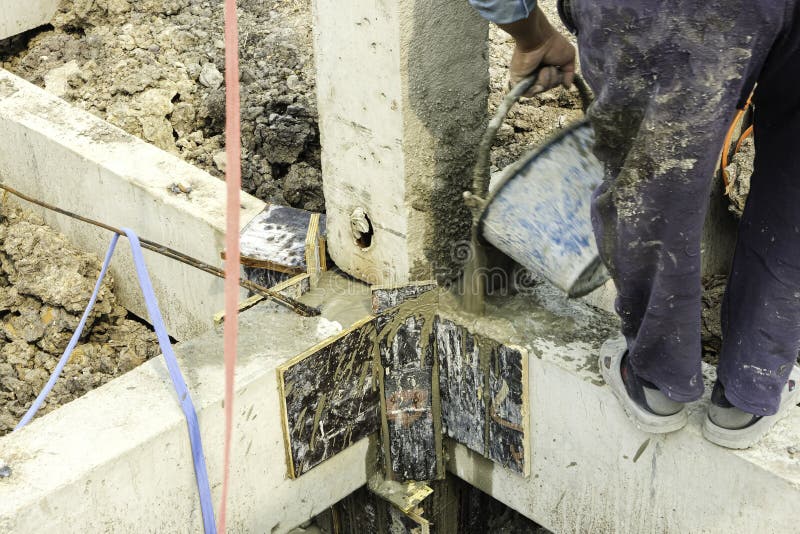 Man Worker Use Blue Plastic Pot Contain Cement Liquid into Pillars