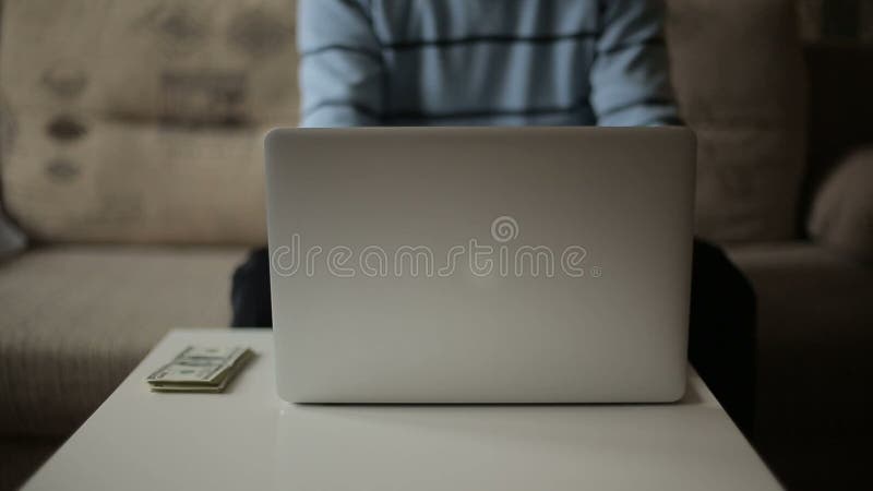 A man working at the computer and make money. Freelancer