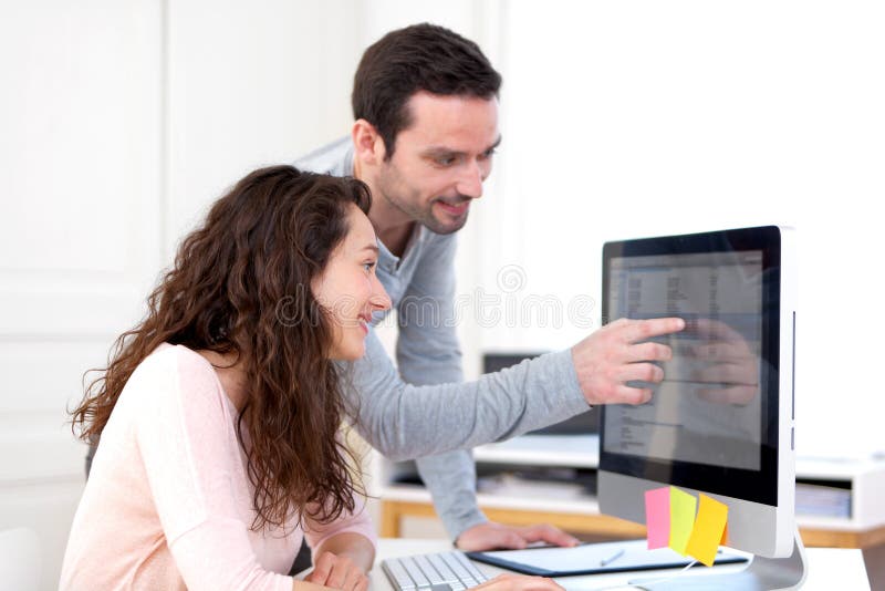 Man working with his co-worker on computer royalty free stock photo Man working with his co-worker on computer royalty free stock photo